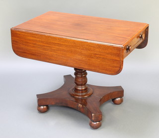 A Victorian mahogany pedestal Pembroke table, raised on a column and triform base with bun feet 27 1/2h x 36"w x 21" when closed x 38" when extended