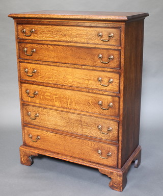 A fine quality oak reproduction chest of 6 long drawers with brass swan neck drop handles, raised on bracket feet 48"h x 36"w x 18"d