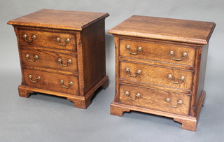 A pair of fine quality oak reproduction bedside chests with canted corners, fitted 3 long drawers with brass swan neck drop handles, raised on bracket feet 24"h x 24"w x 18"d 