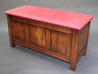 An oak coffer ottoman of panelled construction with upholstered hinged lid 24"h x 48"w x 20 1/2"d 