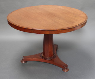 A William IV circular mahogany snap top breakfast table, raised on a chamfered column with triform base and bun feet 32"h x 40" diam. 