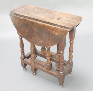 An 18th Century oval oak gateleg drop flap tea table fitted a drawer, raised on turned and block supports 28 1/2"h x 28"w x 10" when closed x 29 1/2" when extended