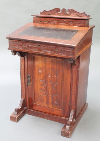 A late Victorian carved mahogany Davenport fitted a stationery box with cupboard beneath enclosed by panelled door 34"h x 21"w x 19"d