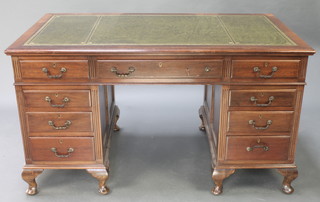 A Chippendale style mahogany desk with green inset writing surface above 1 long and 8 short drawers, the pedestals having fluted decoration to the sides, raised on cabriole supports 31"h x 54"w x 30"d  