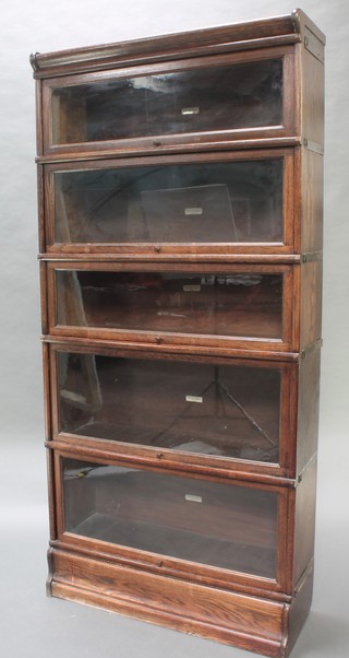 An oak 5 tier Globe Wernicke bookcase, all sections labelled Globe Wernicke, 72"h x 34"w x 12"d 