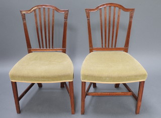 A pair of 19th Century mahogany Hepplewhite stick and rail back dining chairs with overstuffed seats, raised on square tapering supports with H framed stretcher 