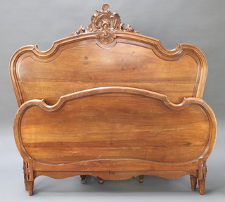 A French carved walnut double panel end bedstead complete with sides and pine slatting to base 60"h at highest point x 77" front to back x 60" wide 