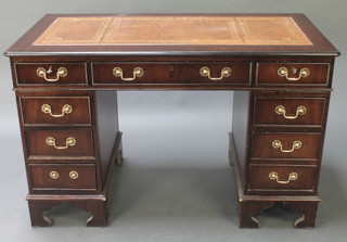 A Georgian style mahogany kneehole pedestal desk with brown inset writing surface above 1 long and 8 short drawers with brass swan neck drop handles 30"h x 48"w 
