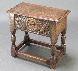 An Ipswich style oak stool with hinged lid, the carved apron decorated a portrait bust raised on turned and block supports 18"h x 19 1/2"w x 10 1/2" 