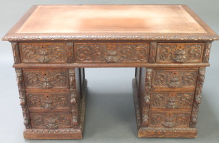 A Victorian carved oak desk with brown inset writing surface above 1 long and 6 short drawers 30"h x 48"w x 30" 