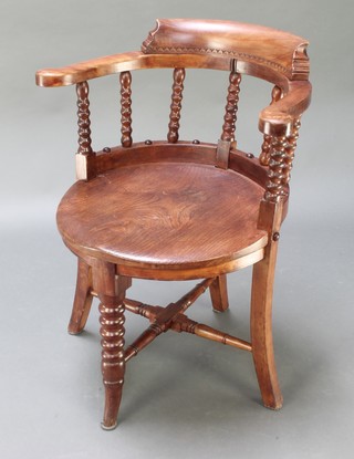 A 19th Century elm tub back chair with bobbin turned decoration on out swept supports with X framed stretcher 
