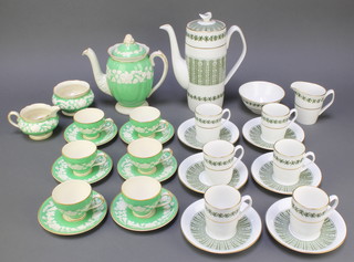 A 15 piece Rhapsody green patterned coffee service comprising coffee pot, cream jug, sugar bowl (cracked), 6 cups, 6 saucers (2 of each cracked) together with a 13 piece Spode Provence coffee service - coffee pot, cream jug, sugar bowl (cracked), 6 coffee cans, 6 saucers (4 cracekd)