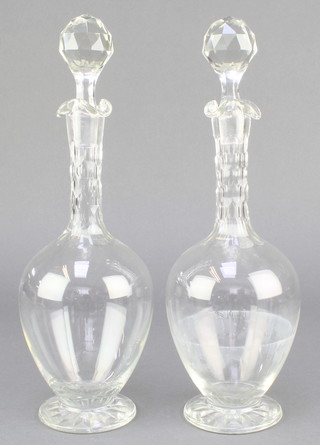A pair of 19th Century club shaped decanters and stoppers 12"