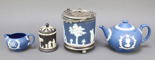 A Wedgwood circular blue Jasperware biscuit barrel and cover with plated mounts, raised on bun feet 6", a ditto black Jasperware jar and cover 4" and a Wedgwood blue Jasperware Coronation teapot and cream jug 597 second grade 