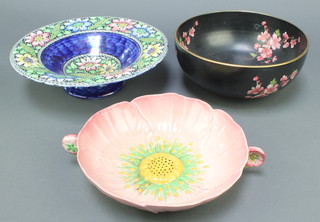 A circular Maling Ware pedestal bowl raised on a spreading foot 6329 11" (cracked), a Carltonware black glazed bowl with floral decoration 8 1/2" and ditto dish in the form of a flower head 9" (cracked) 