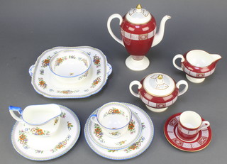 A 14 piece Wedgwood Asia pattern coffee service with coffee pot, twin handled sugar bowl, cream jug, 6 saucers and 5 coffee cans and a 38 piece Aynsley blue banded and floral patterned tea service comprising 2 twin handled plates, 12 tea plates, cream jug, sugar bowl (cracked) 12 saucers (2 cracked), 10 cups (2 cracked)  