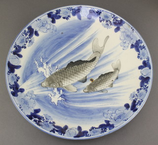 An early 20th Century Japanese plate decorated with carp enclosed by flowers 12" 