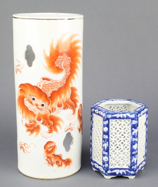 A Chinese cylindrical vase decorated with shi shi having script and pierced quatrefoil decoration 11 1/2" and a blue and white hexagonal pierced vase 5" 
