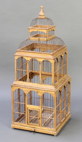 An Eastern wooden and metal square bird cage 41"h x 16" square 