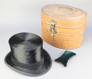 A gentleman's black silk top hat by Dunn & Co. size 7 1/4 complete with oval metal hatbox 