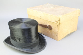 A Dunn & Co. gentleman's black silk top hat, approx. size 7 1/4 complete with cardboard box