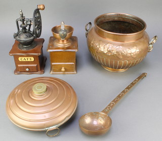 A Soutter Ware embossed copper twin handled jardiniere 8 1/2", a circular copper and brass foot warmer 11", a copper ladle and 2 reproduction coffee grinders