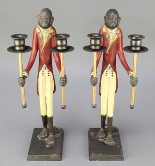 A pair of bronze twin light candelabrum supported by figures of liveried monkey footman, raised on rectangular bases 17" 
