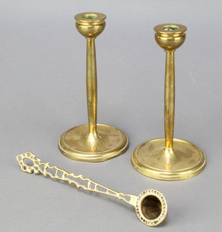 A pierced brass candle snuffer 9 1/2" and a pair of Art Nouveau brass candlesticks 7 1/2" 