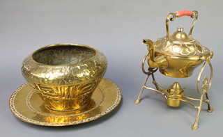 An Art Nouveau Townshend & Co patent circular brass tea kettle and stand, an Eastern brass jardiniere 6",  a brass charger 13" and a brass oil lamp with glass chimney  