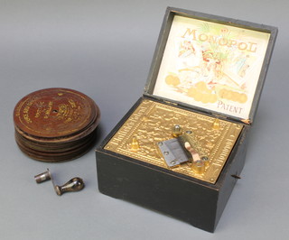 A 19th Century Monopol patent polyphon contained in a wooden box with hinged lid marked Ehrlich's patent together with 26 6" discs