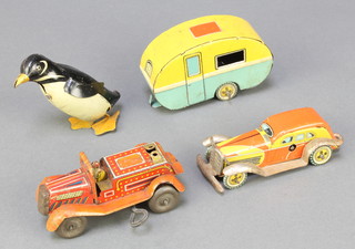 A Japanese clockwork tin plate model of a penguin (no key) 2", a tin plate model of a car marked CK (no key and some rust), a tin plate model of a clown "fire engine" marked KKI together with a tin plate model caravan KC 