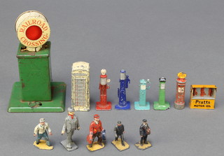 A tin plate railroad crossing sign 4 1/2", 4 Dinky Meccano petrol pumps (2f), a Pratts Motor oil stand, a telephone box,  a pillar box and 5 metal figures 