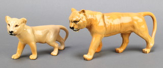 A Beswick figure of a walking lion cub 7" and 1 other of a lioness 9"