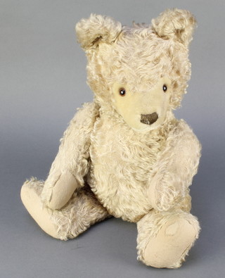 A Steiff yellow mohair bear with articulated limbs 20" (pads worn in places), fitted with a growler 