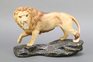 A Beswick matt glazed figure of a standing lion on a rocky outcrop 8 1/2" 