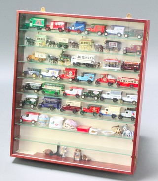 A mahogany wall mounting display cabinet containing a collection of Oxford die cast Days Gone model cars, Lledo and other toy model cars 