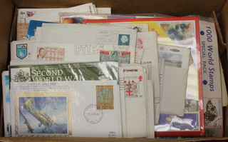 A collection of first day covers, stamped envelopes, loose stamps etc 