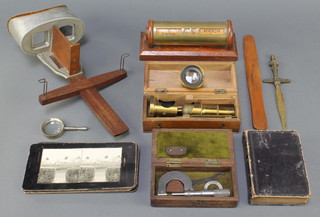 A Sun Sculftur stereoscopic viewer together with 4 home made slides, an oak perpetual desk calendar, a table top magnifying glass, 1 volume Rabenhorst Pocket Dictionary 1835, a paper knife, students brass single pillar microscope and a WGE Barry micrometer 