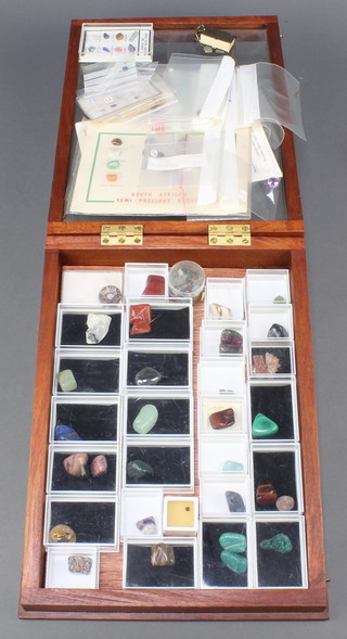 A collection of polished hard stones, contained in a small slope shaped display box with hinged lid 