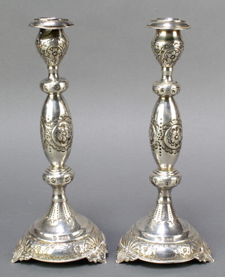 A pair of Victorian silver baluster repousse candlesticks, raised on 3 panelled supports, London 1834, 10 1/2"h,  354 grams