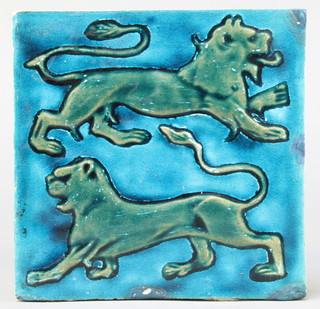 William De Morgan, a turquoise and green glazed tile decorated with 2 walking lions in relief 6" x 6" 