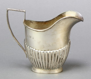 An Edwardian helmet shaped silver cream jug with demi-reeded decoration Birmingham 1901, marks rubbed 94 grams 