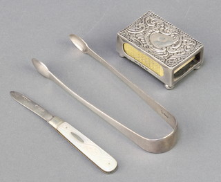 A pair of Georgian silver sugar nips, a silver match box holder and a ditto mother of pearl fruit knife 