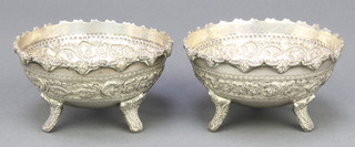 A pair of Indian silver bowls with repousse decoration on scroll feet 188 grams, 3 1/2" 