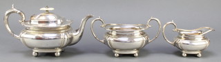 A silver plated 3 piece tea set with gadrooned rim and ball feet 