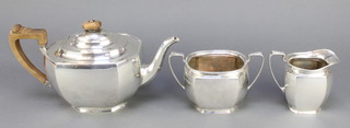 A silver 3 piece tea set with fruitwood handles Birmingham 1931, gross 1094g 