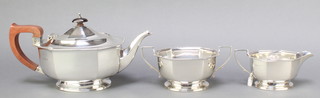 A silver 3 piece tea set with fruitwood mounts, London 1949, gross 880 grams