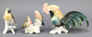 Karl Ens, a German porcelain figure of a cockerel 11" , 1 other of 2 birds by a nest 6" and 1 of a bird on a branch 6"  