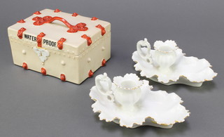 A 19th Century Continental porcelain trinket box in the form of a trunk marked Waterproof 3"h x 4"w x 5"d (chip to the side) and 2 Continental porcelain chamber sticks 