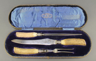 An Edwardian cased set of carvers with horn handles